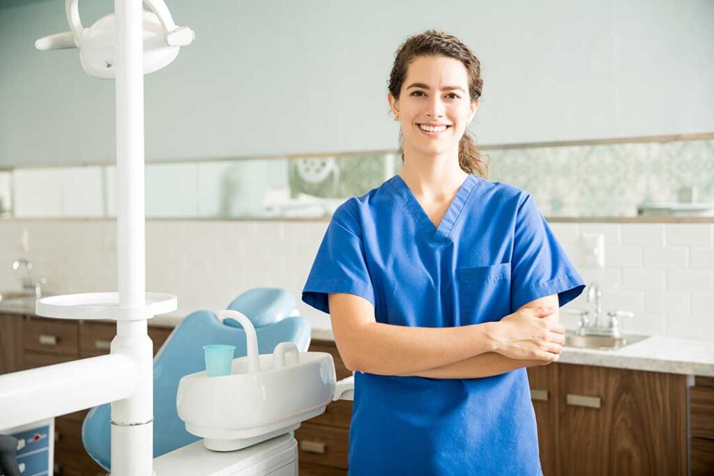 Person brushing teeth with a soft-bristled toothbrush, focusing on gumline, in a brightly lit bathroom.