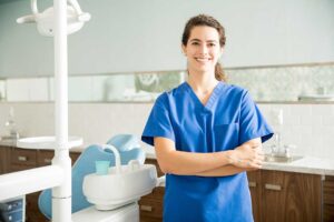 Person brushing teeth with a soft-bristled toothbrush, focusing on gumline, in a brightly lit bathroom.